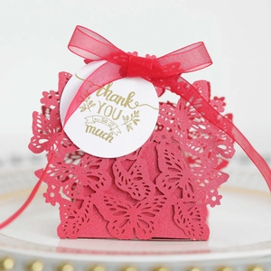 Close-up of red laser-cut butterfly gift box with chiffon ribbon and Thank You tag