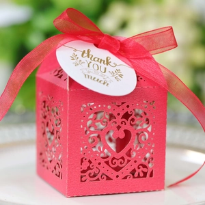 Detail of red hollow heart gift box with a silk ribbon and golden thank you tag