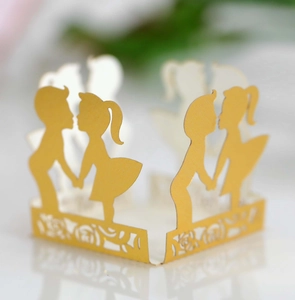 Detail of laser-cut gold paper wrapper featuring romantic boy and girl silhouette