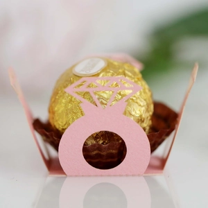 Close-up of pink diamond-shaped paper chocolate holder for wedding party decor