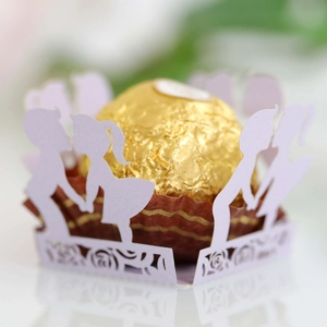Close-up of laser-cut lavender chocolate wrapper with romantic couple silhouette