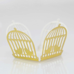 Laser-cut golden birdcage cupcake wrapper with intricate bird silhouettes for weddings