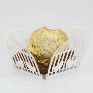 Macro detail of laser cut birdcage pattern on white wedding favor decorative box