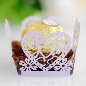 Macro shot of light purple laser-cut heart paper wrappers for festive chocolate packaging