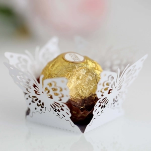 Detail view of laser-cut white butterfly chocolate wrapper with elegant hollow wings
