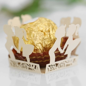 Laser-cut ivory paper chocolate liner with romantic couple silhouette for wedding decor