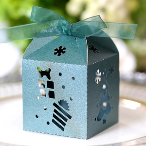 Detail of laser-cut Christmas tree candy box in teal green with elegant organza ribbon