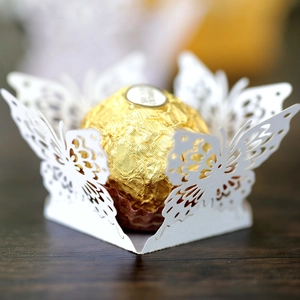 Laser-cut butterfly chocolate wrapper in white pearlescent paper for wedding party decor