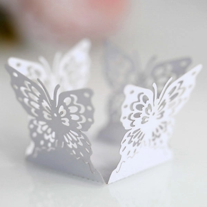 Macro shot of white laser-cut paper butterfly decoration with intricate hollow details