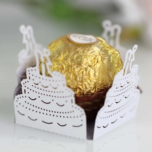 Detail of white laser-cut hollow paper favor box with romantic couple silhouette