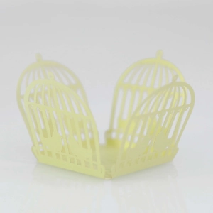 Laser-cut wedding favor box featuring birdcage patterns and intricate bird silhouettes