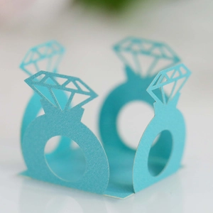 Laser-cut light blue pearl paper chocolate wrappers with diamond ring silhouette