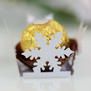 Detailed view of laser-cut white snowflake hollow chocolate holder for festive parties