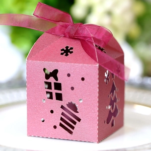 Close-up of pink hollow Christmas favor box with glitter finish and sheer ribbon bow