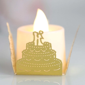 Elegant gold laser-cut paper lampshade featuring wedding cake silhouette with LED candle