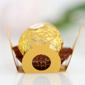 Macro view of gold diamond ring-shaped paper holder for Ferrero chocolate party decoration