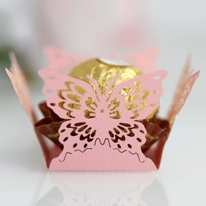 Macro shot of laser-cut pink butterfly candy holder with high precision hollow engraving