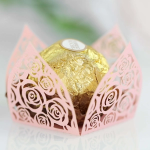 Macro detail of laser-cut pink rose lace wrapper for chocolate party decoration