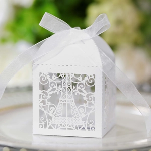 Detailed laser-cut white Eiffel Tower candy box with an elegant white ribbon bow