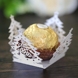 Macro detail of laser-cut Christmas tree chocolate holder made of white art paper