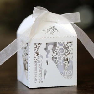 Detailed laser-cut Mr & Mrs wedding favor box with elegant white ribbon and floral patterns
