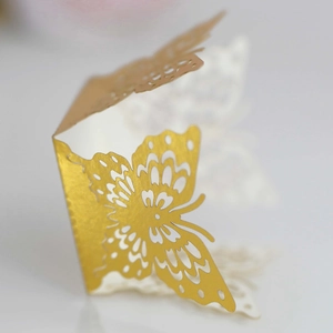 Close-up of golden butterfly hollow paper lampshade with intricate laser-cut wing texture