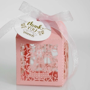 Pink laser-cut Eiffel Tower wedding favor box with translucent ribbon and thank you tag