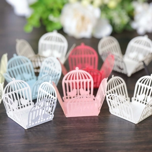 Laser-cut birdcage favor boxes in assorted colors for wedding and party decorations