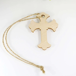 Rustic hollow cut wooden cross ornament with natural jute twine on white background