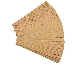 Macro shot of laser-cut hollow pattern details on natural wooden napkin rings