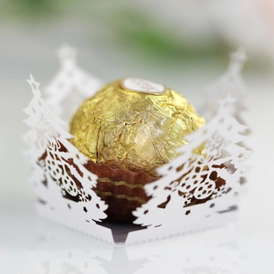 Detail of laser-cut Christmas tree white cardstock holder for ball chocolates