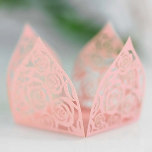 Macro detail of laser-cut rose hollow candy box in pearlescent pink for wedding decor