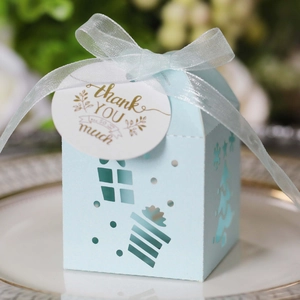 Macro view of light blue hollow Christmas candy box with white ribbon and gift tag