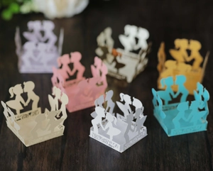 Detailed laser-cut paper favor boxes with romantic couple silhouette for weddings