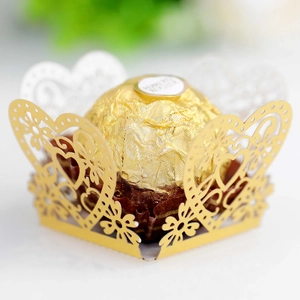 Macro view of gold laser-cut heart pattern candy box with decorative lace detail