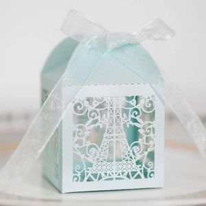 Close-up of light blue laser-cut candy box with Eiffel Tower design and white ribbon bow