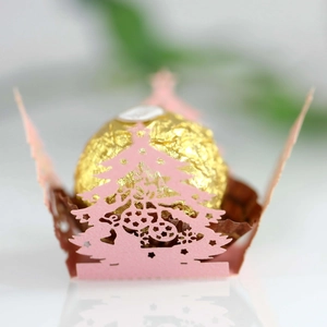 Laser-cut pink paper candy holder with Christmas tree design for chocolates and gifts