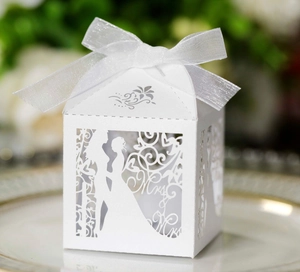 Detailed laser-cut white wedding favor box featuring Mr & Mrs silhouettes with silk ribbon