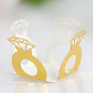 Close-up of laser-cut glitter paper ring decor for wedding cakes and party tables