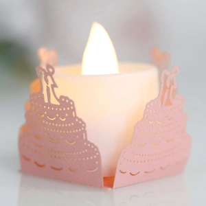 Macro detail of pink laser-cut paper cake lampshade with romantic LED tea light candle