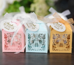 Detail of laser-cut Eiffel Tower favor boxes with ribbons and Thank You tags