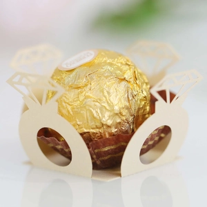 Macro detail of laser-cut ring-shaped paper candy holder for wedding chocolate