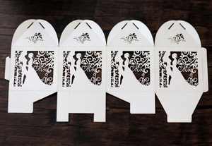 Detailed laser-cut white Mrs paper candy box featuring elegant bride silhouettes and patterns