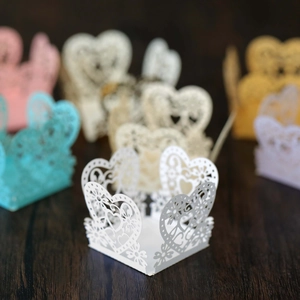 Close-up of laser-cut heart pattern on decorative paper cupcake liners and candy boxes