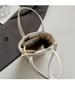 Top view of white leather bucket bag interior showing spacious storage for daily essentials