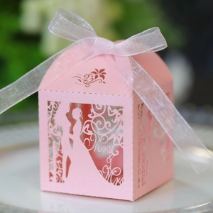 Pink laser-cut house candy box with bridal silhouette and white ribbon bow