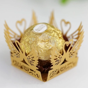 Golden laser-cut swan chocolate holder with delicate hollow flower pattern and square base