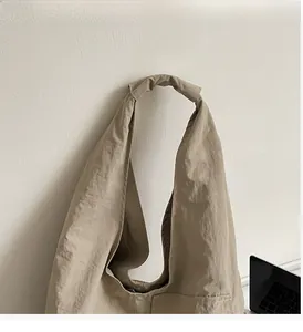 Detail showing the comfortable knotted shoulder strap and natural wrinkled fabric texture