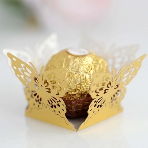 Close-up of laser-cut gold butterfly chocolate box with intricate hollow patterns