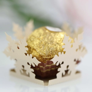 Close-up of laser-cut snowflake hollow chocolate holder for Christmas party favors